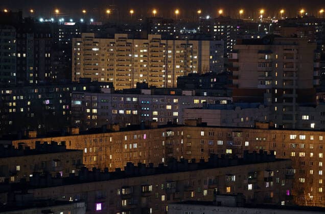 ST PETERSBURG, RUSSIA - APRIL 5, 2020: Lit windows in apartment blocks in Nevsky District. A home isolation order was declared for St Petersburg residents of all ages to restrict movement within the city and reduce the risk of coronavirus contagion, effective since March 30, 2020; a period off work with full pay was extended until April 30 nationwide as part of preventive measures to contain the spread of the COVID-19 infection. Peter Kovalev TASS  TS0D4806