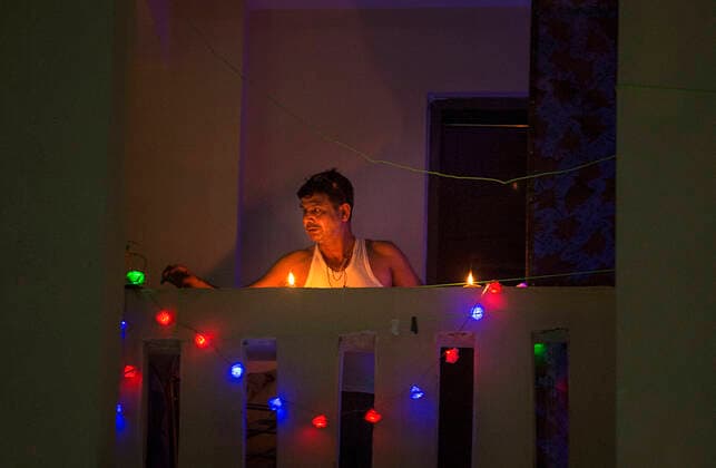 (200405) -- NEW DELHI, April 5, 2020 -- An Indian man illuminates his balcony to mark the country s fight against the COVID-19 pandemic in New Delhi, India, on April 5, 2020. India s health ministry Sunday evening said the death toll due to COVID-19 in India rose to 83 and the total number of confirmed cases in the country reached 3,577. ) INDIA-NEW DELHI-COVID-19-LIGHTING JavedxDar 