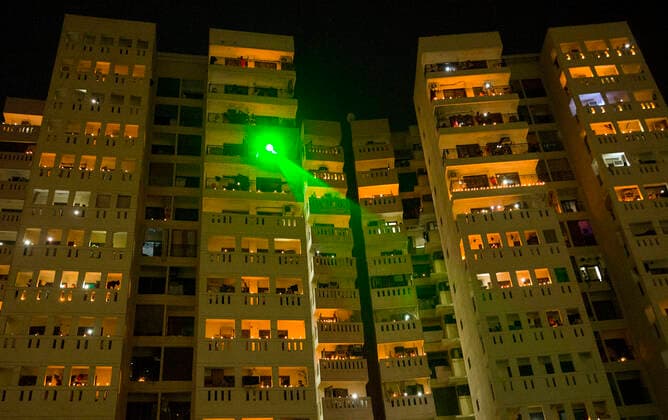 (200405) -- NEW DELHI, April 5, 2020 -- Residential buildings are illuminated by candles, earthen lamps, and flashlights to mark the country s fight against the COVID-19 pandemic in New Delhi, India, on April 5, 2020. India s health ministry Sunday evening said the death toll due to COVID-19 in India rose to 83 and the total number of confirmed cases in the country reached 3,577. ) INDIA-NEW DELHI-COVID-19-LIGHTING JavedxDar 