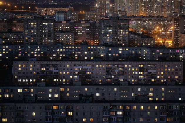 ST PETERSBURG, RUSSIA - APRIL 5, 2020: Lit windows in apartment blocks in Nevsky District. A home isolation order was declared for St Petersburg residents of all ages to restrict movement within the city and reduce the risk of coronavirus contagion, effective since March 30, 2020; a period off work with full pay was extended until April 30 nationwide as part of preventive measures to contain the spread of the COVID-19 infection. Peter Kovalev TASS  TS0D4808