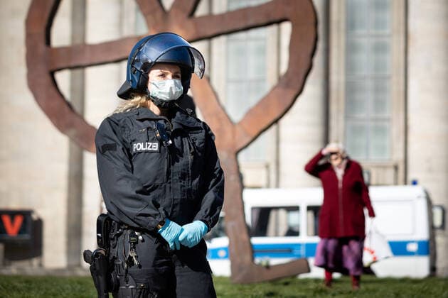 Conspiracy theorists protest gg Corona Restrictions A policewoman with a breathing mask in front of the Volksbühne on the edge of a demonstration of conspiracy theorists during the containment ordinance with exit restriction, ban on demonstrations and contact ban to contain the COVID 19 pandemic Coronavirus SARS CoV 2 in Berlin Â Berlin Berlin Germany