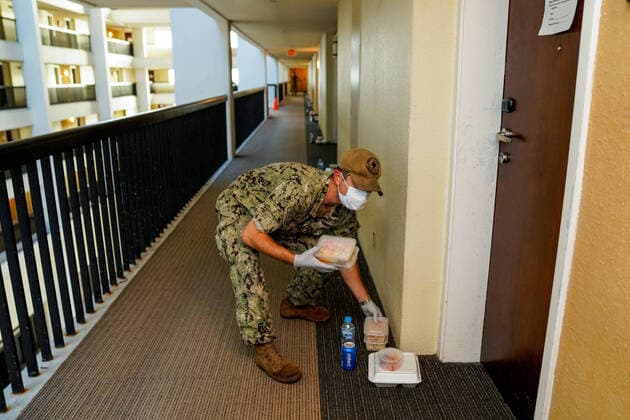 April 3, 2020, Tamuning, Guam, United States: A U.S. Navy sailor delivers food to hotel rooms where sailors from the aircraft carrier USS Theodore Roosevelt who have tested negative for COVID-19 are quarantined April 3, 2020 in Tamuning, Guam. The sailors will be required to remain in quarantine for at least 14 days. Previously the ships commanding officer Capt. Brett Crozier was relieved of duty March 31, 2020 after pleading for help to stem the spread of COVID-19 cases on his ship. Tamuning United States - ZUMAp138 20200403_zaa_p138_009 Copyright: xKelseyxHockenberger Planetpixx
