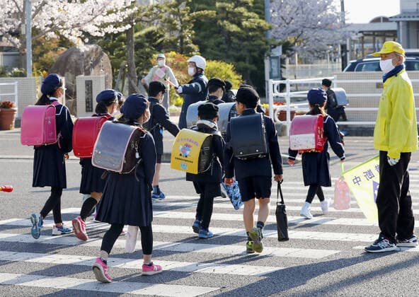 New coronavirus Elementary school students head to school in Saga, southwestern Japan, on April 6, 2020, as the new school year begins. Elementary and high schools had been closed in Japan since early March due to the coronavirus outbreak. 