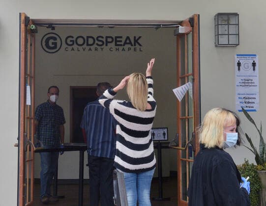 Parishioners practice social distancing guidelines as they line up to partake in the sacrament of communion-not services to kick off Holy Week despite county and state orders restricting non-essential travel at the Godspeak Calvary Chapel in the Newbury Park town of Thousand Oaks, California on Sunday, April 5, 2020. Millions of Christians around the world will spent Palm Sunday watching church service and taking communion from the comfort of their homes as they seek to abide stay-home orders intended to limit the spread of the coronavirus. File  LAP2020040505 JIMxRUYMEN