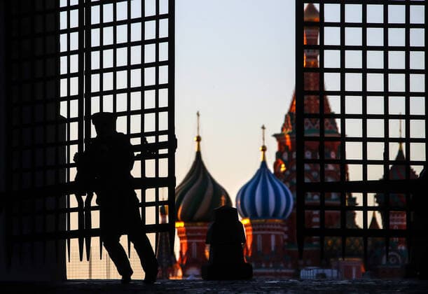 MOSCOW, RUSSIA - APRIL 6, 2020: A police officer at the Iberian Gate in a deserted Red Square during the pandemic of the novel coronavirus (COVID-19). As of 6 April 2020, Russia has reported more than 6,300 confirmed cases of the novel coronavirus, with more than 4,400 confirmed cases in Moscow. Since 30 March 2020, Moscow has been on lockdown in connection with the pandemic. The Russian government announced a paid period off work for employed people and school holidays, which is expected to last till the end of April. Valery Sharifulin TASS  TS0D4856