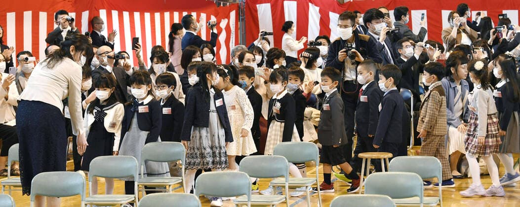 New coronavirus New students wear face masks during an enrollment ceremony at Kosai Elementary School in Sapporo, Japan, on April 6, 2020, amid concerns over coronavirus infections. (Pool photo) 
