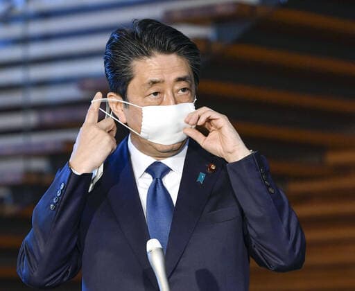Abe to declare state of emergency Japanese Prime Minister Shinzo Abe takes his mask off before announcing plans to declare a state of emergency over the spread of the new coronavirus on April 6, 2020, in Tokyo. 