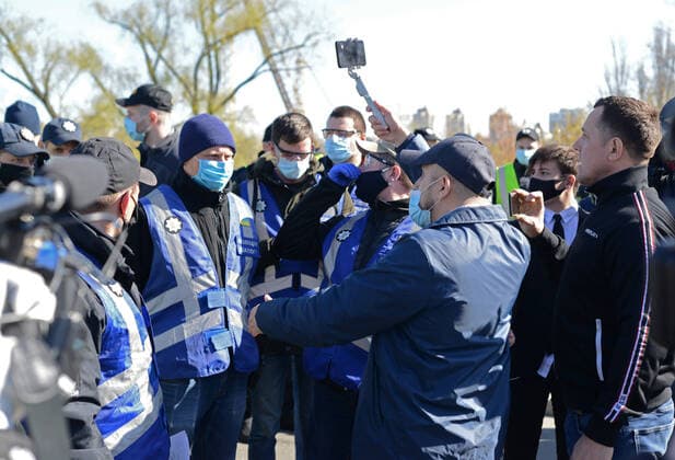 KYIV, UKRAINE - APRIL 06, 2020 - Men speak with the police officers who block the way to the closed sports ground, Kyiv, capital of Ukraine. Police block entrance to Hydropark sports ground in capital  Copyright: xYevhenxKotenkox