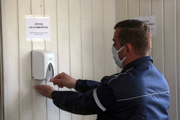 KYIV, UKRAINE - APRIL 06, 2020 - Man disinfectshis hands with a sanitizer, Kyiv, capital of Ukraine. Medical examination for public transport drivers conducted in Kyiv  Copyright: xYuliiaxOvsyannikovax