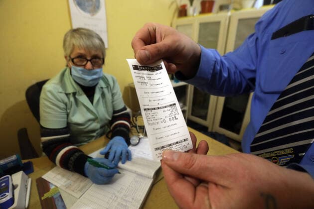 KYIV, UKRAINE - APRIL 06, 2020 - Public transport driver geceives the results of his blood alcohol test before going on the route, Kyiv, capital of Ukraine. Medical examination for public transport drivers conducted in Kyiv  Copyright: xYuliiaxOvsyannikovax