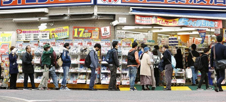 New coronavirus People wait in line in front of a drugstore in Tokyo to buy masks on April 6, 2020, amid concerns over the new coronavirus. 