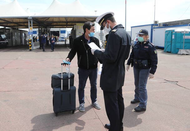 A Coast Guard officer check a passenger just disembarked from the Catania Grimaldi ferry that brought at home 105 Italians citizens evaquated from Tuinisia. In Italy the lockdown still continue Government Decree declaring all of Italy a protected area to combat covid-19 - coronavirus infection, closing schools, public offices and shops.  Copyright: xCarloxHermannx xIPAx xKontrolabx