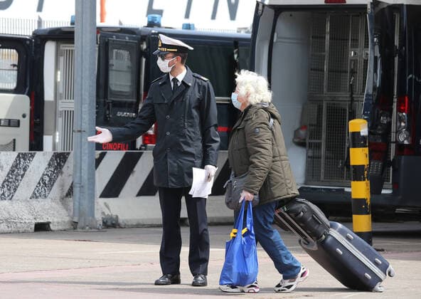 A Coast Guard officer check apassenger just disembarked from the Catania Grimaldi ferry that brought at home 105 Italians citizens evaquated from Tuinisia. In Italy the lockdown still continue Government Decree declaring all of Italy a protected area to combat covid-19 - coronavirus infection, closing schools, public offices and shops.  Copyright: xCarloxHermannx xIPAx xKontrolabx
