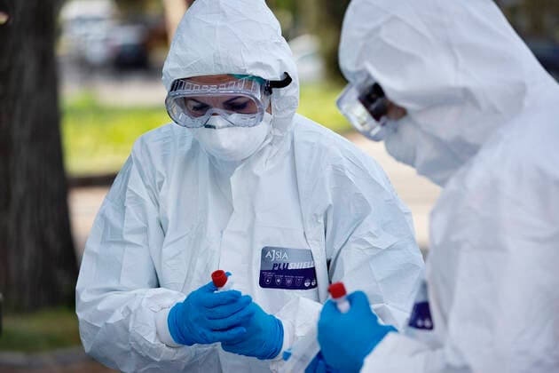 April 6, 2020, Roma, Roma, Italy: The collection of swab samples by medical staff in a drive-in testing center in Roma to check the Coronavirus (Covid-19).Health workers are dressing with protective suits..The Italian Government is still adopting the measure of a national lockout by closing all activities, except for essential services in an attempt to fight Coronavirus (COVID-19) .All the city, as all the whole country, is under quarantine and the movement are restricted to the necessary. Roma Italy - ZUMAt147 20200406_zip_t147_001 Copyright: xMatteoxTrevisanx