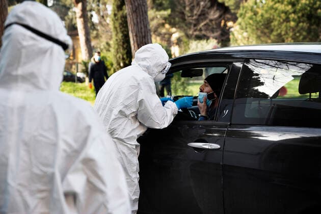 April 6, 2020, Roma, Roma, Italy: The collection of swab samples by medical staff in a drive-in testing center in Roma to check the Coronavirus (Covid-19).Health workers are dressing with protective suits..The Italian Government is still adopting the measure of a national lockout by closing all activities, except for essential services in an attempt to fight Coronavirus (COVID-19) .All the city, as all the whole country, is under quarantine and the movement are restricted to the necessary. Roma Italy - ZUMAt147 20200406_zip_t147_005 Copyright: xMatteoxTrevisanx