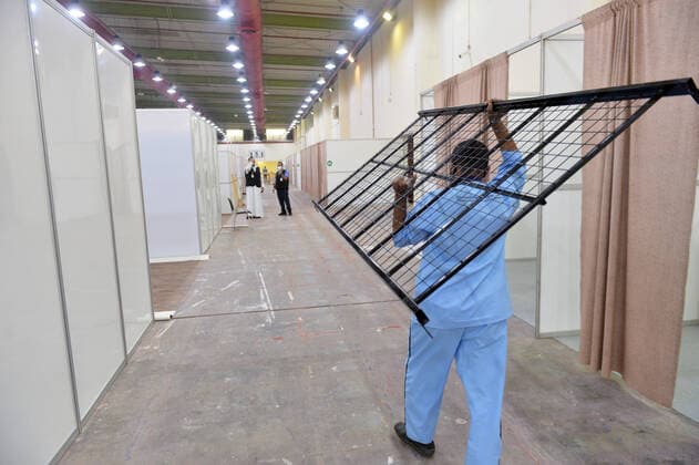 (200406) -- HAWALLI GOVERNORATE, April 6, 2020 (Xinhua) -- A worker carries a bedstead into a new quarantine center in Hawalli Governorate, Kuwait, April 6, 2020. Kuwaiti government set up on Monday a new quaratine center in Hawalli Governorate. (Photo by Asad Xinhua) KUWAIT-HAWALLI GOVERNORATE-COVID-19-NEW QUARANTINE CENTER 