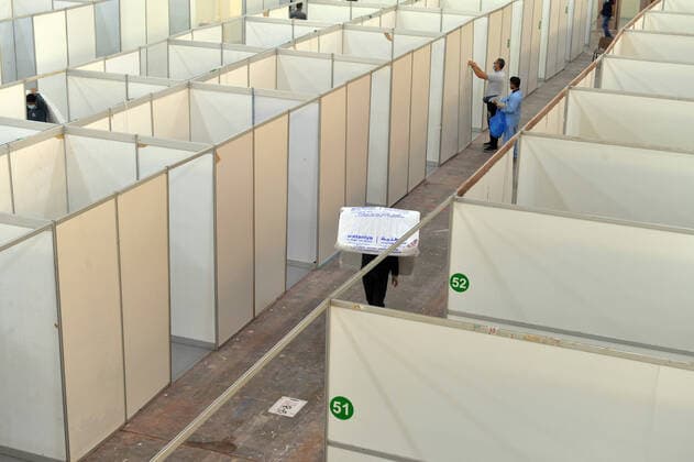 (200406) -- HAWALLI GOVERNORATE, April 6, 2020 (Xinhua) -- Photo taken on April 6, 2020 shows a worker carrying a mattress in a new quarantine center in Hawalli Governorate, Kuwait. Kuwaiti government set up on Monday a new quaratine center in Hawalli Governorate. (Photo by Asad Xinhua) KUWAIT-HAWALLI GOVERNORATE-COVID-19-NEW QUARANTINE CENTER 