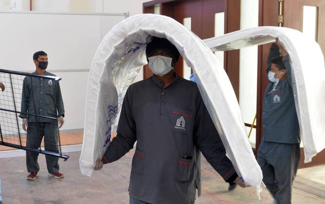 (200406) -- HAWALLI GOVERNORATE, April 6, 2020 (Xinhua) -- Workers carry mattresses into a new quarantine center in Hawalli Governorate, Kuwait, April 6, 2020. Kuwaiti government set up on Monday a new quaratine center in Hawalli Governorate. (Photo by Asad Xinhua) KUWAIT-HAWALLI GOVERNORATE-COVID-19-NEW QUARANTINE CENTER 