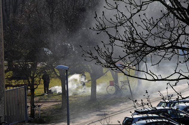 Copenhagen Denmark. 06.April 2020 Danes enjoying summer day in in summer weather buring small fire in park unknonw reason of fire while sun shine over Kastrup nd keep social distance f rom on and other during corona cirus crisis covid-19 in Denmark. (Photo..Francis Dean Deanpictures).