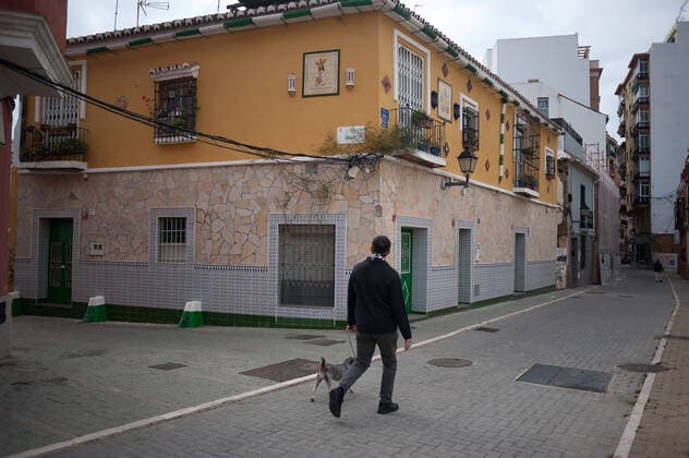 April 6, 2020, Malaga, Spain: An image of Christ is seen placed on the top of a house as a man walks outside an empty street during a Holy Monday in downtown Malaga..The traditional Easter celebration has been cancelled in Spain. Believers live an unusual Holy Week in their homes, for that reason many people decorate their balconies or place decorative statues of Christ in their shops and stores. After the alarm state and lockdown in the country by COVID-19 coronavirus all people are enclosed in their homes following the confinement decreed by the Spanish government and which will be extended for more 15 days until 26 April. Malaga Spain - ZUMAs197 20200406_zaa_s197_022 Copyright: xJesusxMeridax