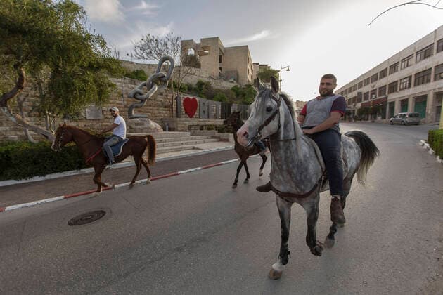 April 6, 2020, Bethlehem, West Bank: Palestinian ride their horses in the alost-empty streets of Bethlehem during the closure for more than a month. Bethlehem West Bank - ZUMAb133 20200406_zap_b133_001 Copyright: xMustafaxBaderx
