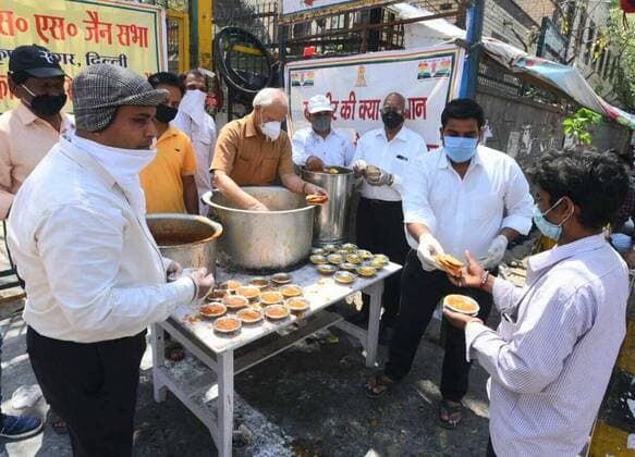 NEW DELHI, INDIA - APRIL 6: Food and water being distributed on the occasion of Mahavir Jayanti at Jain Sthanak Krishna Nagar, on day thirteen of the 21-day nationwide lockdown to check the spread of coronavirus on April 6, 2020 in New Delhi, India. (Photo by Sonu Mehta Hindustan Times) Government And NGOs Provide Food To Homeless And Poor Amid Lockdown To Prevent Covid-19