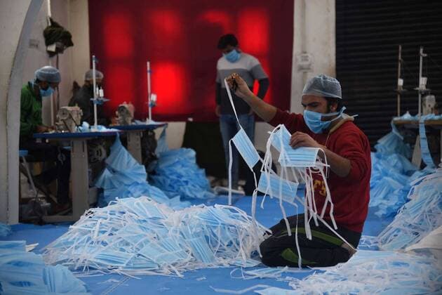 SRINAGAR, INDIA - APRIL 6: Worker make face masks to meet their demands in view of the spread of novel coronavirus pandemic on day thirteen of the 21-day nationwide lockdown to check the spread of coronavirus at a private manufacturing unit in Rangreth area on April 6, 2020 on the outskirts of Srinagar, India. (Photo by Waseem Andrabi Hindustan Times) Worker Make Face Masks In View Of The Spread Of Novel Coronavirus Covid-19 Pandemic