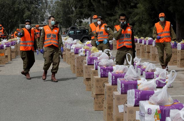 (200406) -- BNEI BRAK, April 6, 2020 (Xinhua) -- Israeli soldiers prepare to collect and pack for distributing food packages to local citizens in the central Israeli city of Bnei Brak, on April 6, 2020. According to Israel s Ministry of Health, a total of 474 people in Israel were tested positive for COVID-19 on Monday, bringing the tally of infections to 8,904. (Photo by Gil Cohen Magen Xinhua) MIDEAST-BNEI BRAK-COVID-19 