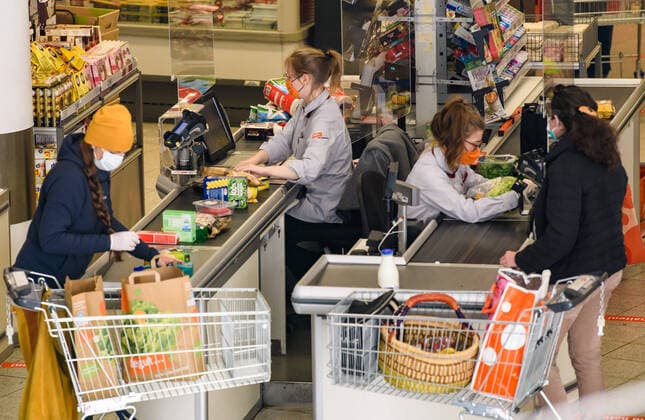 (200407) -- BERLIN, April 7, 2020 (Xinhua) -- Cashiers and customers wearing face masks are seen at a supermarket in Jena, Germany, April 6, 2020. The eastern German city of Jena became the first in the country to make wearing a protective face mask mandatory in public areas, such as shops, on public transportation and in buildings with public access during the COVID-19 pandemic. (Photo by Kevin Voigt Xinhua) GERMANY-JENA-COVID-19-FACE MASKS 