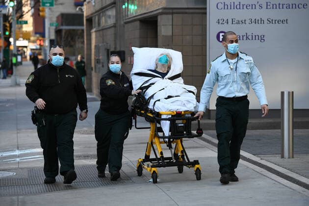 April 6, 2020, New York, New York, United States: Paramedics wheel a patient into NYU Langone Hospital in Manhattan on Monday, the start of what is expected to be the worst week of the Coronavirus pandemic the city has seen so far. New York United States - ZUMAl113 20200406_zap_l113_003 Copyright: xMiguelxJuarezxLugox