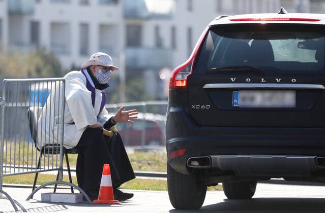 A priest hears confession in the car park outside the Temple of Divine Providence in Warsaw during the coronavirus outbreak A priest hears confession in the car park outside the Temple of Divine Providence during the coronavirus outbreak on April 07, 2020 in Warsaw, Poland EN_01423818_0005 