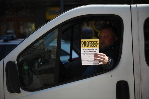 A car protest of the entrepreneurs in Krakow during the coronavirus outbreak A car protest of the entrepreneurs during the coronavirus outbreak on April 07, 2020 in Krakow, Poland. The card reads: The protest of the entrepreneurs. Krakow s Anti-crisis shield. EN_01423820_0010 
