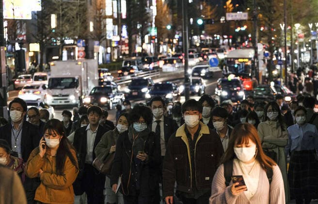 New coronavirus People wearing face masks walk in Tokyo s Shinjuku area on April 7, 2020. Earlier in the day, Japanese Prime Minister Shinzo Abe declared a state of emergency for Tokyo, Osaka and five other prefectures to curb the spread of the new coronavirus. 
