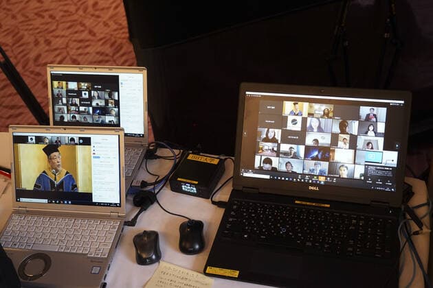April 7, 2020, Tokyo, Japan: A Japanese University has held the world s first online graduation ceremony using robots due to the coronavirus pandemic...Students at Business Breakthrough University in Tokyo didn t get a traditional ceremony, but had the next best thing using newme telepresensence robots and a tablet hosting a Zoom call...Graduates had the experience of walking across the stage and accepting their diplomas at the Hotel Grand Palace in Tokyo, virtually on March 28, all while self-isolating at home...The robots were dressed in a cap and gown and fitted with tablets on their heads, allowing students to show their face using Zoom...When the moderator called the name, a newme wearing a graduation gown and hat from BBT University appeared on the tablet with the face of the graduate who operated it, and the diploma was hande - ZUMAc218 20200407_zia_c218_018 Copyright: xCOVERxImagesx