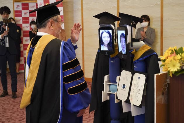 April 7, 2020, Tokyo, Japan: A Japanese University has held the world s first online graduation ceremony using robots due to the coronavirus pandemic...Students at Business Breakthrough University in Tokyo didn t get a traditional ceremony, but had the next best thing using newme telepresensence robots and a tablet hosting a Zoom call...Graduates had the experience of walking across the stage and accepting their diplomas at the Hotel Grand Palace in Tokyo, virtually on March 28, all while self-isolating at home...The robots were dressed in a cap and gown and fitted with tablets on their heads, allowing students to show their face using Zoom...When the moderator called the name, a newme wearing a graduation gown and hat from BBT University appeared on the tablet with the face of the graduate who operated it, and the diploma was hande - ZUMAc218 20200407_zia_c218_016 Copyright: xCOVERxImagesx