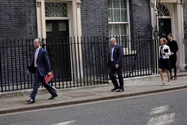 (200407) -- LONDON, April 7, 2020 (Xinhua) -- British Foreign Secretary Dominic Raab (1st L) leaves 10 Downing street after the COVID-19 committee meeting in London, Britain, April 7, 2020. British Prime Minister Boris Johnson was taken to intensive care on Monday night after his coronavirus symptoms worsened, Downing Street said. Johnson has asked British Foreign Secretary Dominic Raab to deputize for him, a Downing Street spokesman said. (Photo by Tim Ireland Xinhua) BRITAIN-LONDON-COVID-19 
