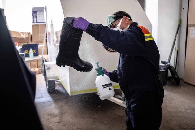 April 7, 2020, Girona, Spain: A civil protection agent disinfects safety boots..During the Covid-19 crisis, the civil protection agents of Gerona carry out disinfection tasks in the residences for the elderly. Girona Spain - ZUMAs197 20200407_zaa_s197_051 Copyright: xMartixNavarrox