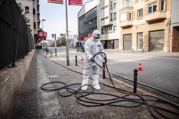 April 7, 2020, Girona, Spain: A civil protection agent dressed in a protective suit sprays disinfectants on the streets in front of a senior center..During the Covid-19 crisis, the civil protection agents of Gerona carry out disinfection tasks in the residences for the elderly. Girona Spain - ZUMAs197 20200407_zaa_s197_054 Copyright: xMartixNavarrox