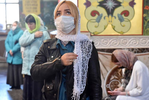 STAVROPOL TERRITORY, RUSSIA - APRIL 7, 2020: Russian Orthodox believers in face masks attend a service in the Cathedral of Christ the Saviour Healing An Infirm Man At The Pool of Bethesda, in the city of Pyatigorsk, on the feast day of the Annunciation, during the pandemic of the novel coronavirus (COVID-19). Anton Podgaiko TASS  TS0D4B0E