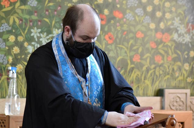 STAVROPOL TERRITORY, RUSSIA - APRIL 7, 2020: A Russian Orthodox priest in a face mask in the Cathedral of Christ the Saviour Healing An Infirm Man At The Pool of Bethesda, on the feast day of the Annunciation, in the city of Pyatigorsk, during the pandemic of the novel coronavirus (COVID-19). Anton Podgaiko TASS  TS0D4B14