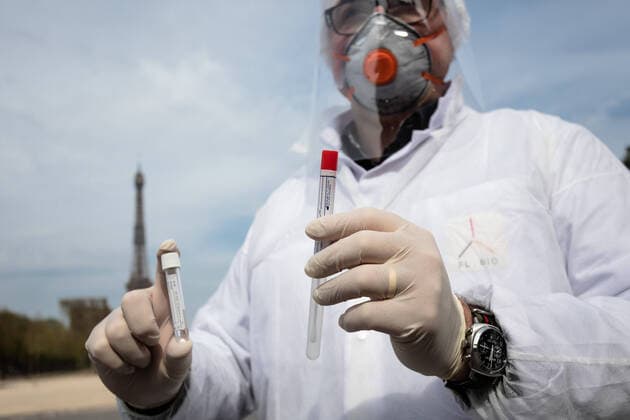 (200407) -- PARIS, April 7, 2020 (Xinhua) -- A biologist from Eylau Unilabs Analysis Laboratories is pictured at a COVID-19 drive-through testing station near Champs de Mars in Paris, France, April 7, 2020. (Photo by Aurelien Morissard Xinhua) FRANCE-PARIS-COVID-19-DRIVE THROUGH TEST 