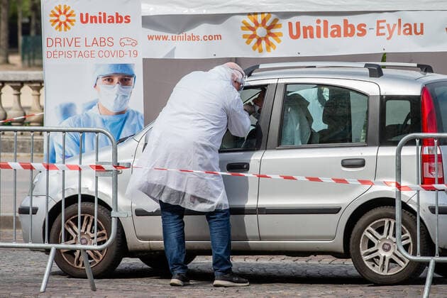 (200407) -- PARIS, April 7, 2020 (Xinhua) -- A biologist from Eylau Unilabs Analysis Laboratories collects a sample from a driver at a COVID-19 drive-through testing station near Champs de Mars in Paris, France, April 7, 2020. (Photo by Aurelien Morissard Xinhua) FRANCE-PARIS-COVID-19-DRIVE THROUGH TEST 