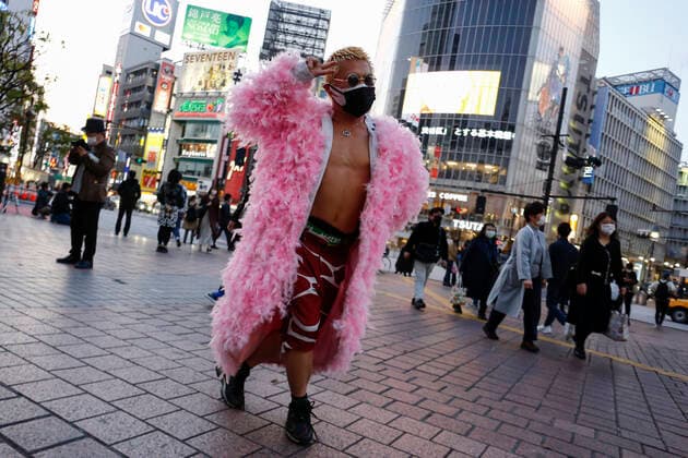 April 7, 2020, Tokyo, Japan: A young man wearing double face masks and a pink coat poses for a photograph in Shibuya. Japanese Prime Minister Shinzo Abe declared a state of emergency for Tokyo and six other prefectures (Kanagawa, Saitama, Chiba, Osaka, Hyogo and Fukuoka) responding to the coronavirus pandemic. Tokyo Japan - ZUMAm191 20200407_zap_m191_019 Copyright: xRodrigoxReyesxMarinx