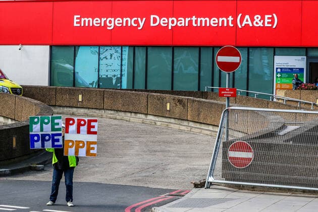 April 7, 2020, London, England, United Kingdom: A woman holding up signs (PPE-Personal Protection Equipment) stands outside St Thomas Hospital in central London as British Prime Minister Boris Johnson is in intensive care fighting the coronavirus in London, Tuesday, April 7, 2020. London United Kingdom - ZUMAx02_ 20200407_zaf_x02_004 Copyright: xVudixXhymshitix