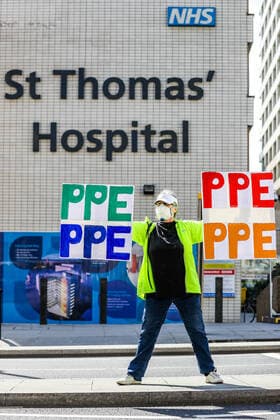 April 7, 2020, London, England, United Kingdom: A woman holding up signs (PPE-Personal Protection Equipment) stands outside St Thomas Hospital in central London as British Prime Minister Boris Johnson is in intensive care fighting the coronavirus in London, Tuesday, April 7, 2020. London United Kingdom - ZUMAx02_ 20200407_zaf_x02_009 Copyright: xVudixXhymshitix