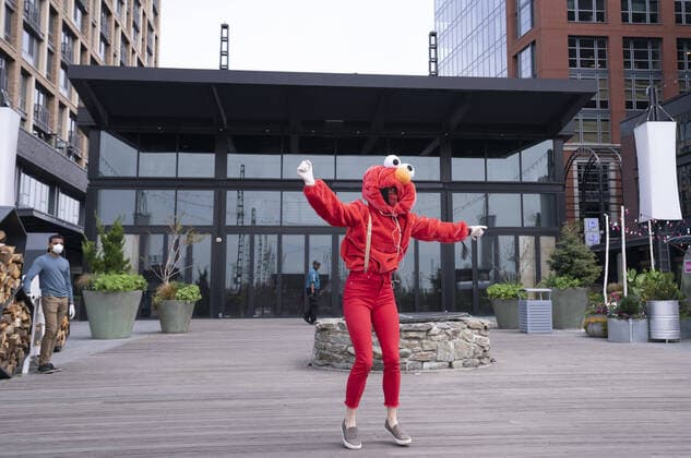 A YouTube performer known as Elmo at the Wharf dances on the Wharf in Washington, D.C. during the Coronavirus pandemic and stay at home order, on Tuesday, April 7, 2020. The performer said she was attempting to bring smiles and joy to the people in the apartment buildings that overlook the area.  WAP20200407312 KEVINxDIETSCH