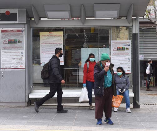 People wear face mask for protection against the coronavirus, while waiting for the train, on Tuesday, March 7, in Jerusalem. Israeli Prime Minister Benjamin announced severe travel restrictions and a curfew for the Passover holiday, as an effort to halt the spread of the coronavirus.  JER2020040705 DEBBIExHILL