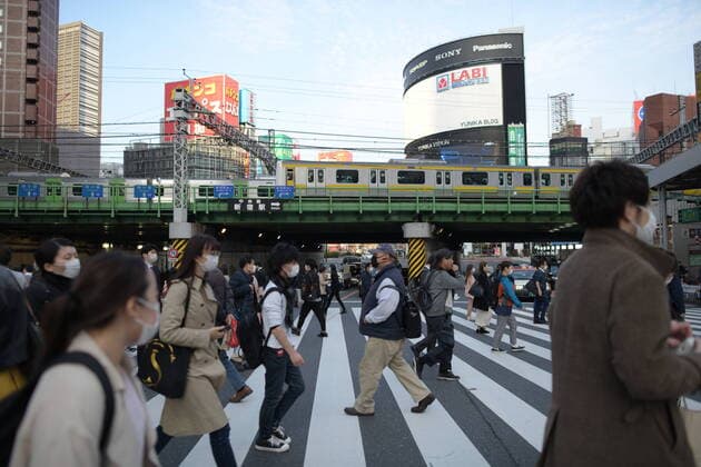 TOKYO, JAPAN - APRIL 7: Pedestrians wearing face masks walk across the road in Shinjuku business district, Tuesday, April 7, 2020, in Tokyo. Japanese Prime Minister Shinzo Abe declared a state of emergency on Tuesday for Tokyo and six other prefectures to ramp up defenses against the spread of the coronavirus. (Photo: Richard Atrero de Guzman AFLO)  (125133553)