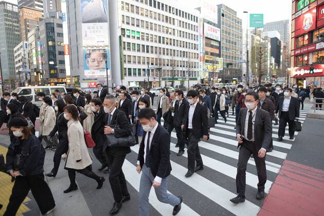 TOKYO, JAPAN - APRIL 7: Pedestrians wearing face masks walk across the road in Shinjuku business district, Tuesday, April 7, 2020, in Tokyo. Japanese Prime Minister Shinzo Abe declared a state of emergency on Tuesday for Tokyo and six other prefectures to ramp up defenses against the spread of the coronavirus. (Photo: Richard Atrero de Guzman AFLO)  (125133558)