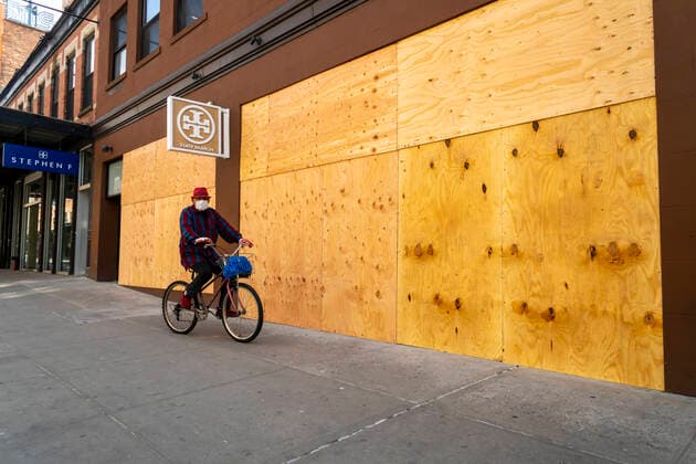 New York during the COVID-19 pandemic Roberto Monticello, the Mayor of Meatpacking bicycles past the closed boarded up Tory Burch store in the Meatpacking District in New York on Monday, April 7, 2020. (  RichardxB.xLevine